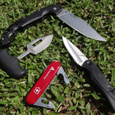 Best knives for self defense - My small collection of knives on the grass