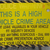 Crime safety tips - A yellow sign saying high vehicle crime area