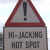 Hijackings - A street sign saying "Hijacking Hotspot" in Joburg, South Africa