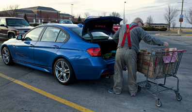 Vehicle Crime - Old man loading groceries into boot of blue car