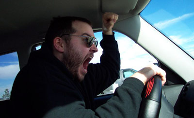 Road rage - A man is shouting at someone while driving