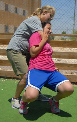 Two women practicing a choke hold