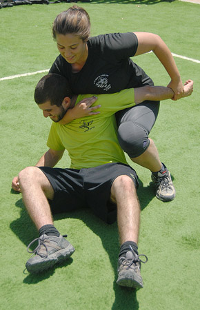 Woman makes a choke hold in self-defense training Stock Photo