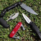 Best knives for self defense - My small collection of knives on the grass