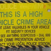 Crime safety tips - A yellow sign saying high vehicle crime area