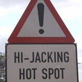 Hijackings - A street sign saying "Hijacking Hotspot" in Joburg, South Africa