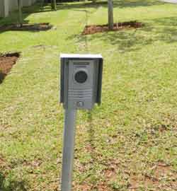 An intercom device on a pole outside the home's gate