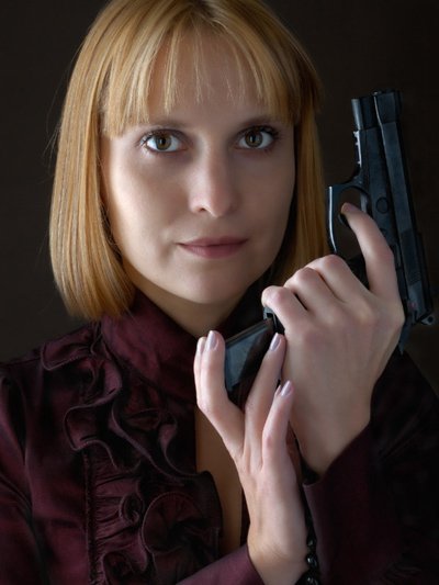 Ladies Weapon - Red haired woman holding black handgun