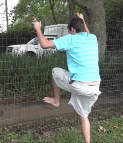 Fence test 3 - Evan climbing over a wire fence barefoot