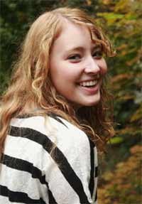 Appearance - A young girl in a striped top smiling at camera